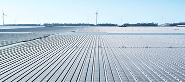 Aerial view of Floating solar power plant and wind turbine farm